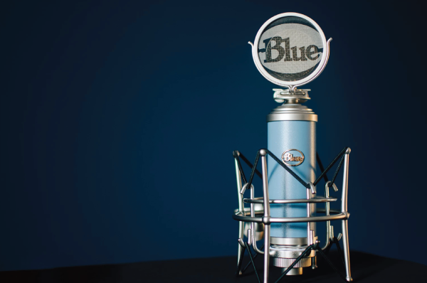 blue microphone in front of dark background