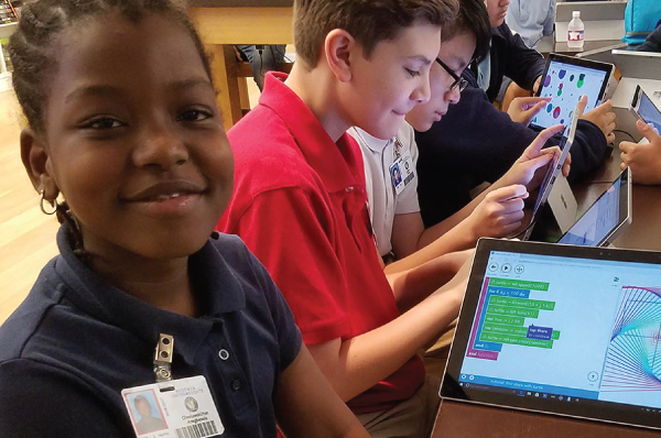 young people using tablets to learn coding