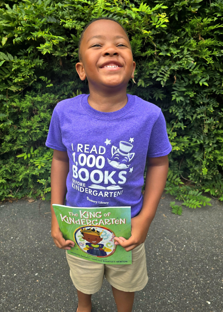 child with book titled "The King of Kindergarten"