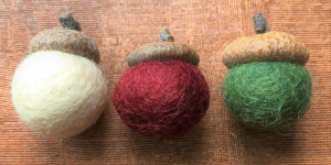 White, red, and green felt spheres with acorn tops.