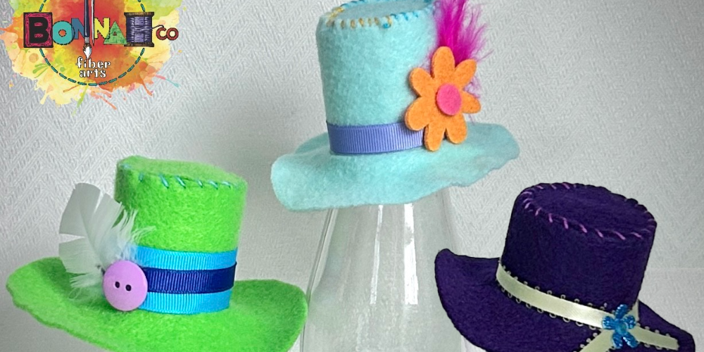 Mini felt hats on three stands