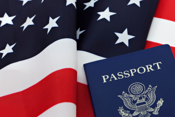 blue passport booklet in front of American flag