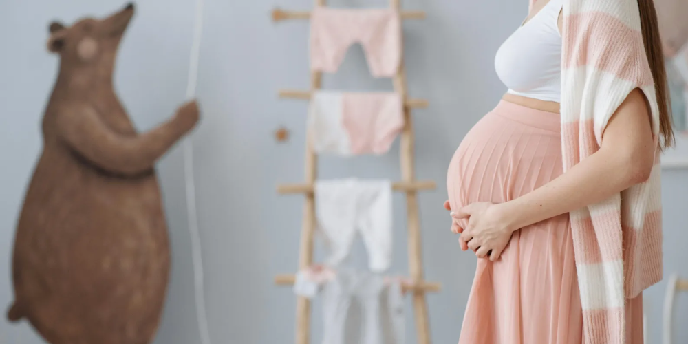 Pregnant woman in white and pink outfit