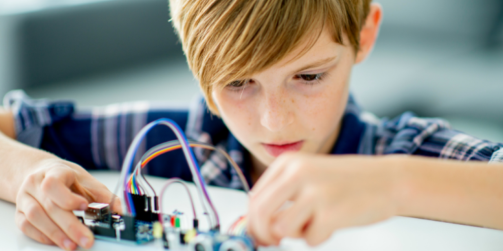 A child looking at wires
