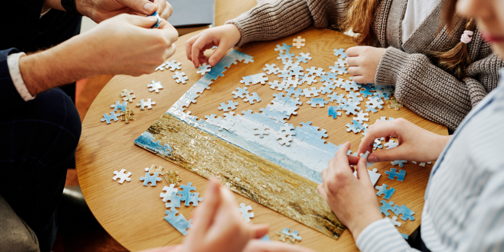 three people solving a puzzle