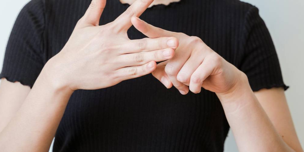 close up of hands signing
