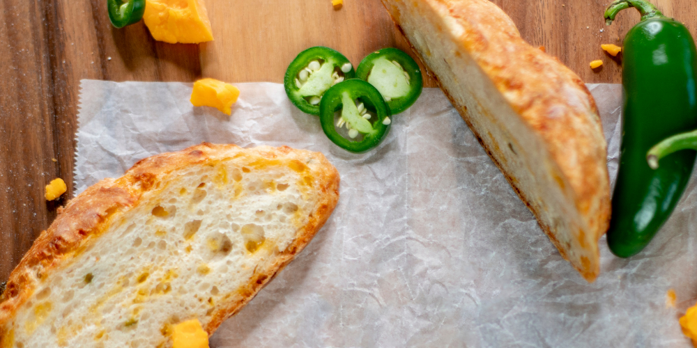 Slices of bread with cut jalapenos