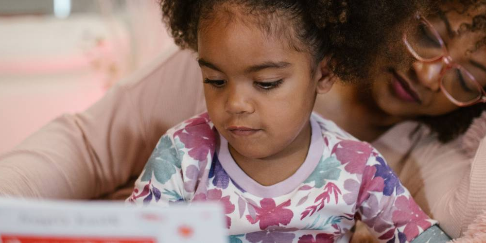 A child and mother reading.