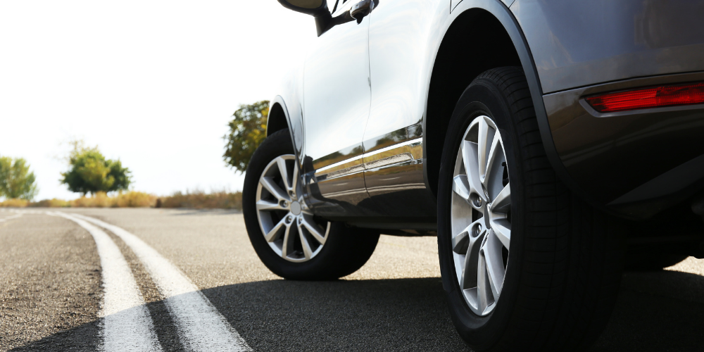 A closeup on a white SUV's driver side
