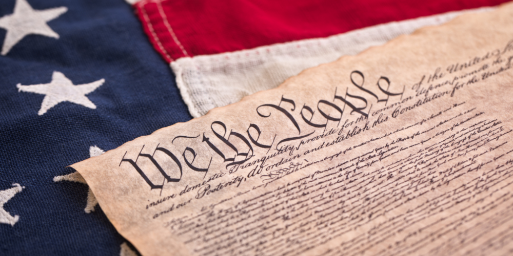 American flag with the Constitution on it.